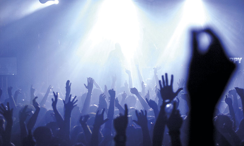 01 Jan 2005, Melbourne, Australia --- Party goers wave their hands in the air at a rave dance party. --- Image by © Julian Smith/Corbis
